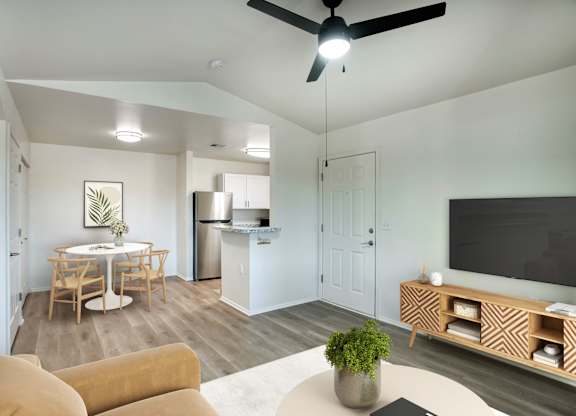 A modern living room with a dining area and kitchen in the background.