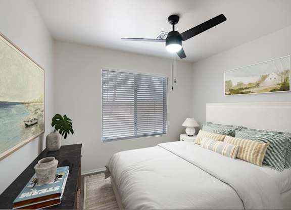 A bedroom with a bed, a ceiling fan, and a painting on the wall.