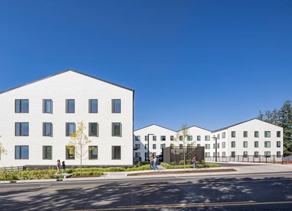 A white building with a clear blue sky in the background.