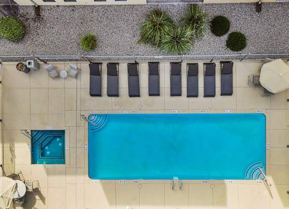 A rectangular pool with a blue tiled border and a white tiled floor.