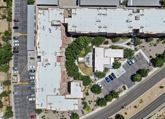 An aerial view of a parking lot and buildings.