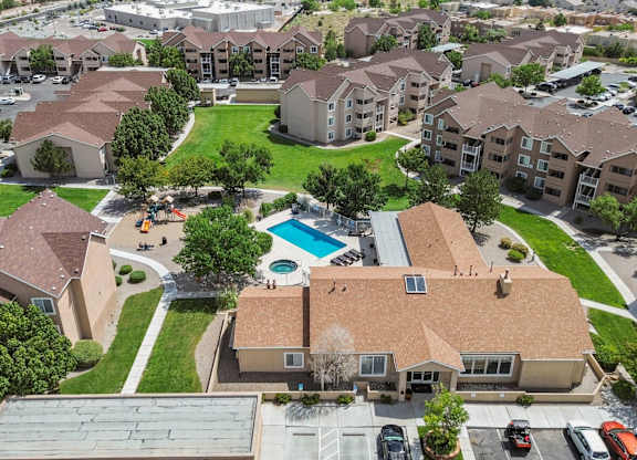 A large apartment complex with a pool in the middle.