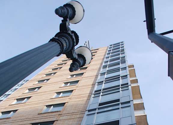 A tall building with a street light in front of it.