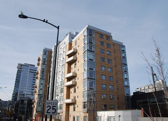 A tall building with a sign that says "SPEED 25" in front of it.