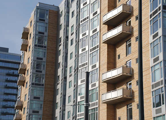 A tall building with balconies on the side.