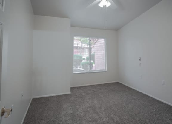 an empty living room with a large window
