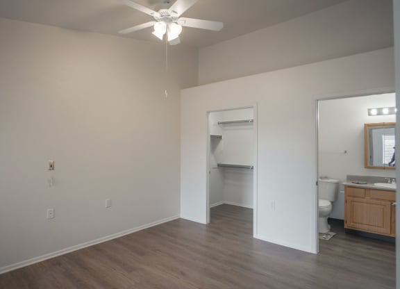 an empty bedroom with a closet and bathroom