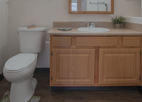 a small bathroom with a toilet sink and mirror