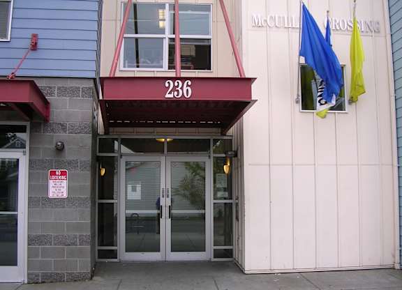 The building has a red awning with the number 236 on it.