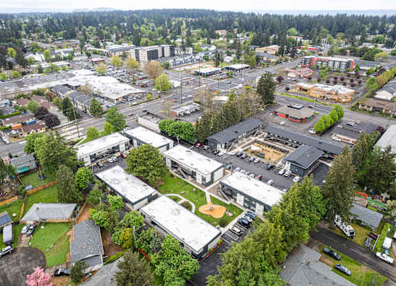 A bird's eye view of a small town with a mix of residential and commercial buildings.