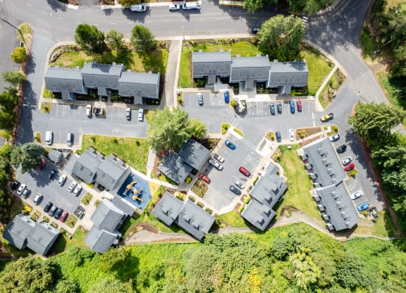 an aerial view of a neighborhood of houses with cars parked