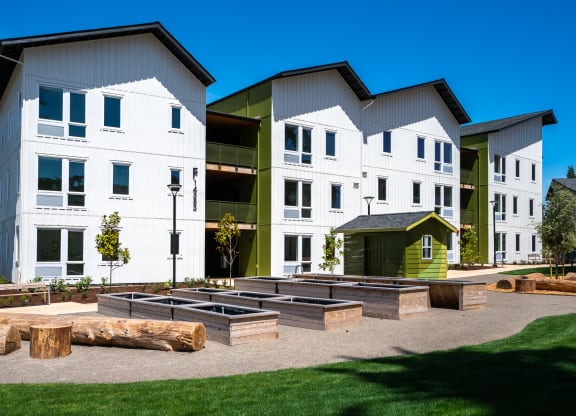 a group of modern buildings with a fire pit in the middle