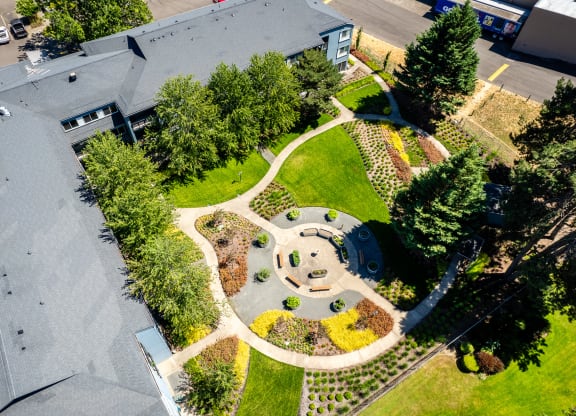 an aerial view of a park with trees and a building