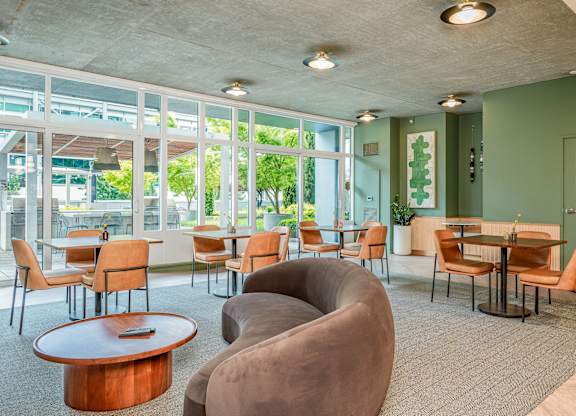A room with a green wall and a table with chairs.
