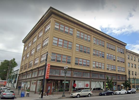 A building with a red sign on the ground floor.