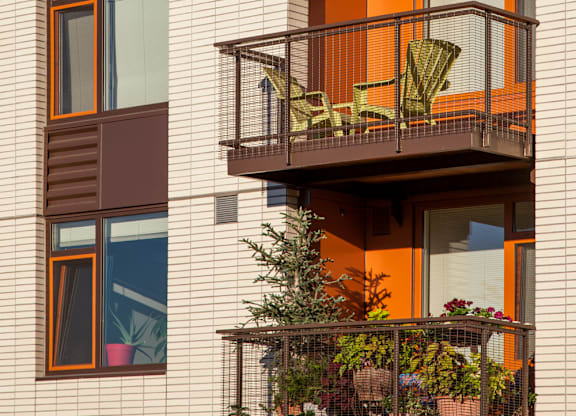 A building with balconies and plants on them.