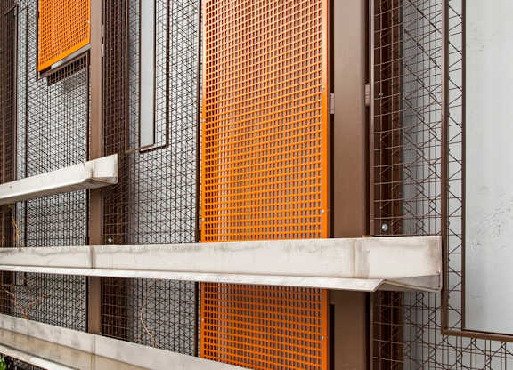 A modern building with a white and orange facade.