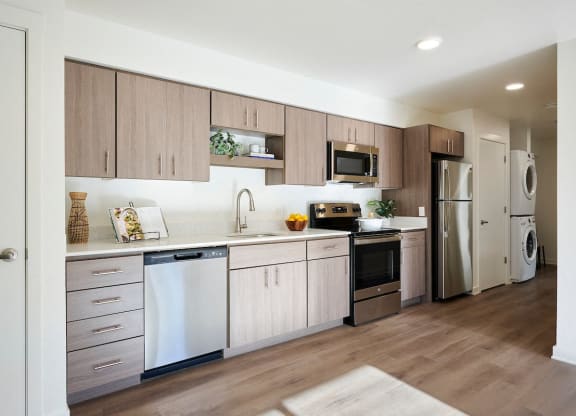 a kitchen with white cabinets and stainless steel appliances