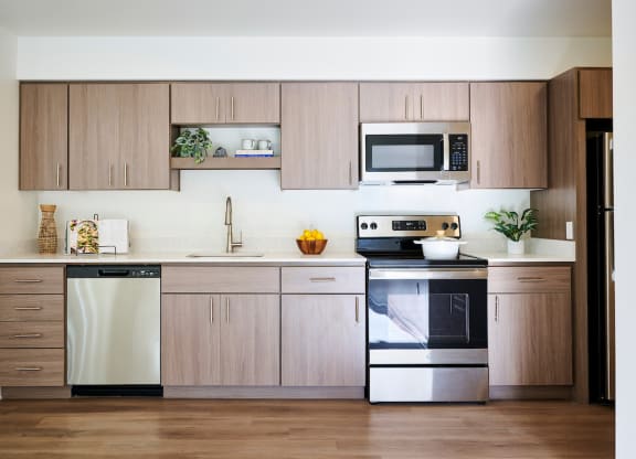 a kitchen with wooden cabinets and stainless steel appliances