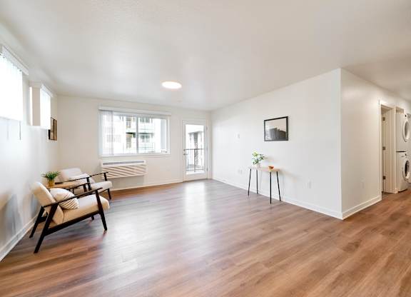 A room with a wooden floor and a chair.