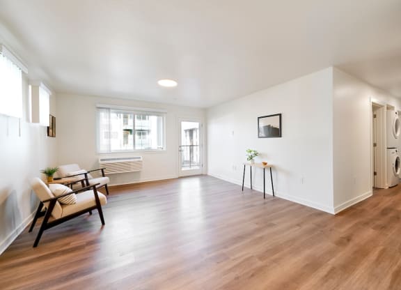 a living room with white walls and a hard wood floor