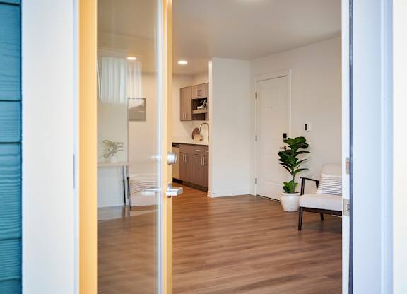 A modern interior with a wooden floor and white walls.