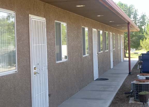 A building with brown walls and white doors and windows.
