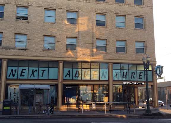 A building with the words "Next Adventure" on the front.