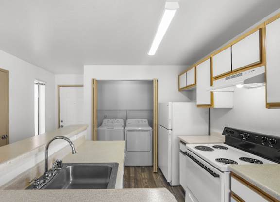 A kitchen with white appliances and a white countertop.