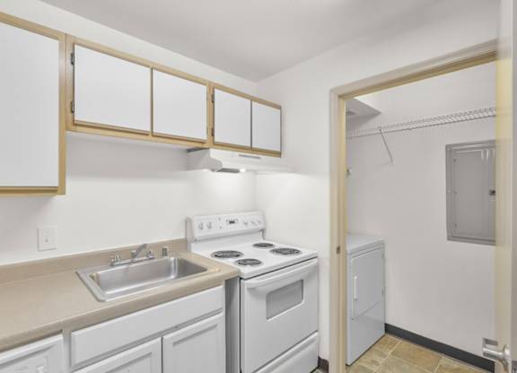 A small kitchen with white appliances and cabinets.