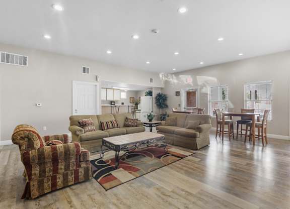 A living room with a sofa, armchair, and coffee table.
