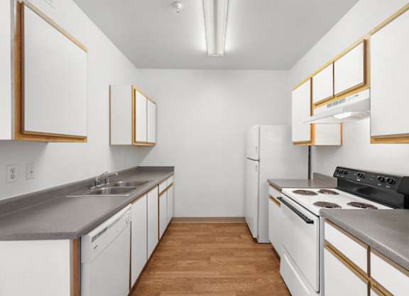 A kitchen with white cabinets and a black stove top oven.