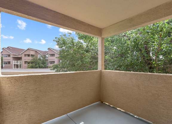 A balcony with a view of a residential area.