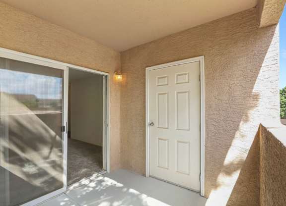 A white door is on the right and a glass door is on the left.