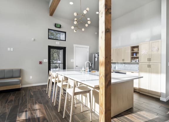a view of a kitchen with a bar and stools
