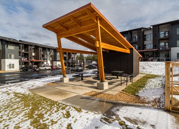 a pavilion with picnic tables in the snow