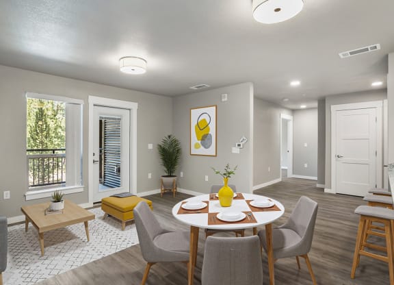 an open living room and dining room with a table and chairs