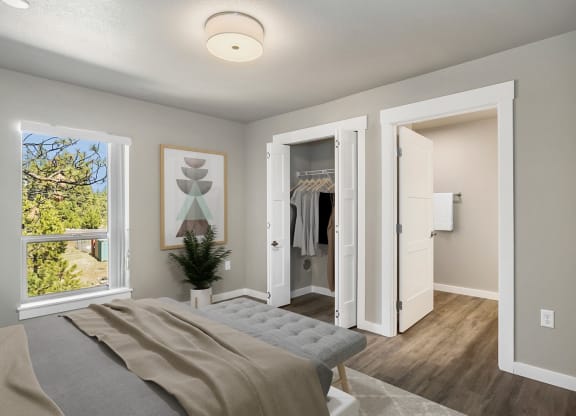 the master bedroom of a new home with a closet and a bed