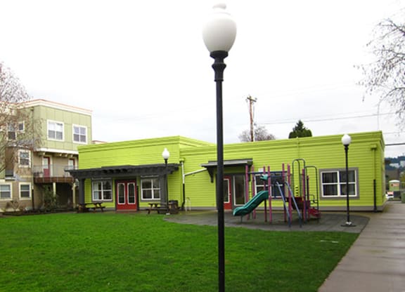 a playground in front of a green building
