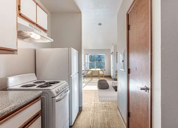 A small kitchen with a stove top oven and a refrigerator.