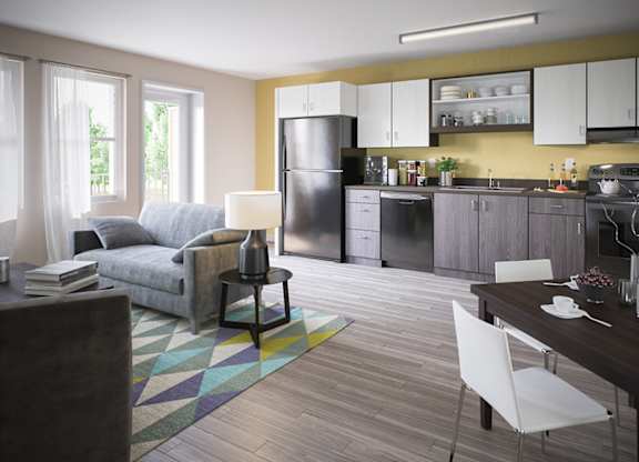 A modern kitchen with a grey fridge and white cabinets.