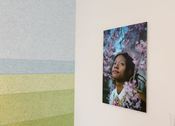 a photo of a painting of a girl with flowers on a wall