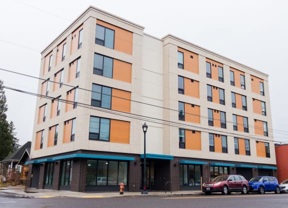 a large building with cars parked in front of it