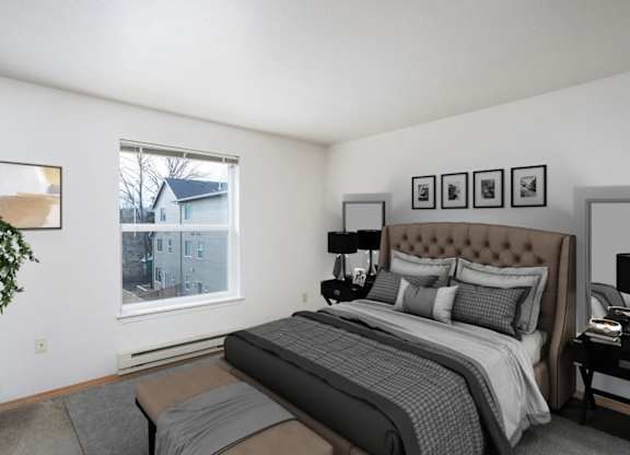 A bedroom with a large bed and a potted plant.