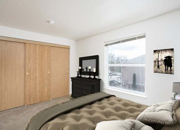 A bedroom with a large bed and a television.