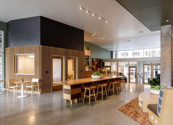 the lobby of a building with a large table and chairs at Slabtown Square Apartments, Portland , Oregon