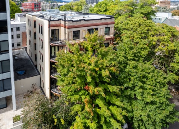 an aerial view of an apartment building with trees