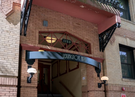 the front of a brick building with an entrance sign
