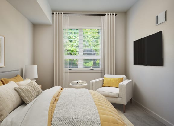 a bedroom with a bed and a chair and a window