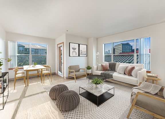A living room with a white couch, a coffee table, and a dining table.